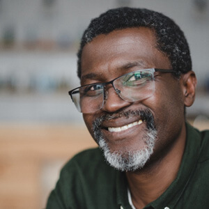 Bearded senior man with glasses smiling