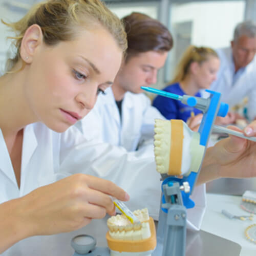 A lab technician making dentures