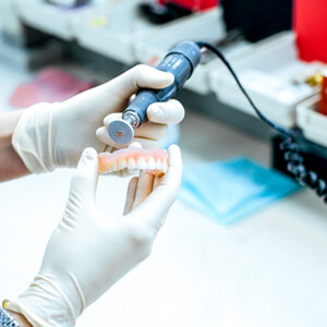 A technician working on a partial denture